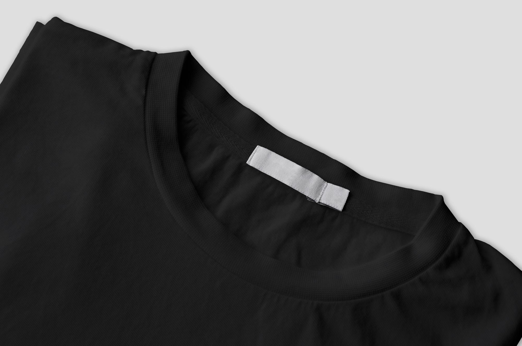 photo-folded-black-tshirt-with-white-label-isolated