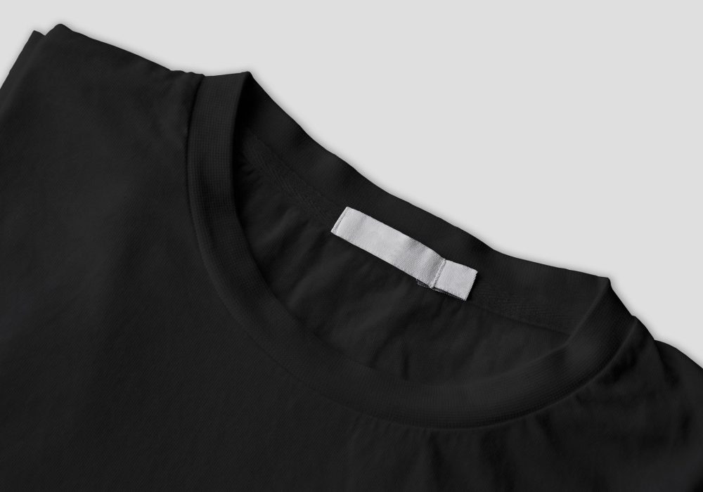 photo-folded-black-tshirt-with-white-label-isolated